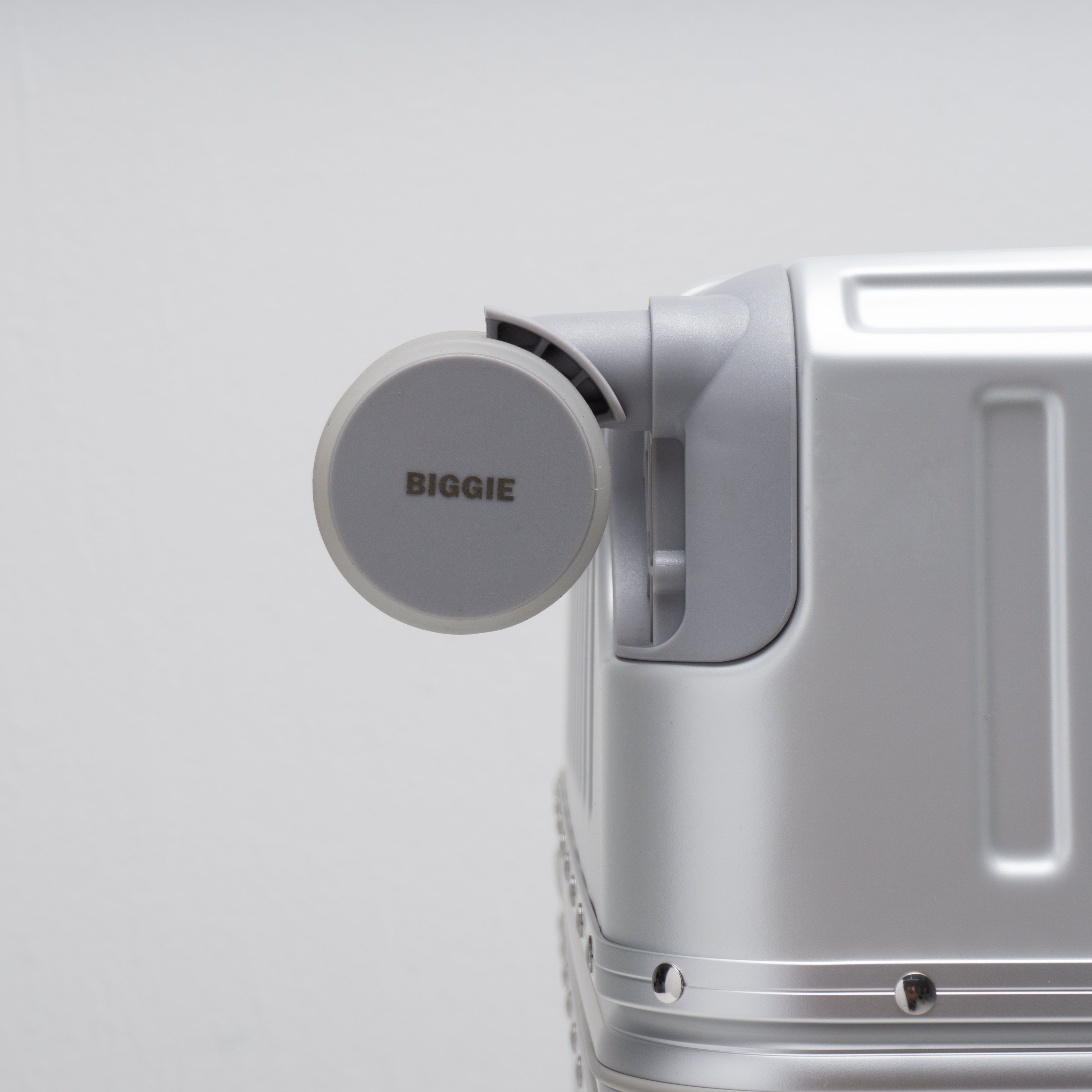 luggage with a double wheels labeled 'BIGGIE' on a light gray background